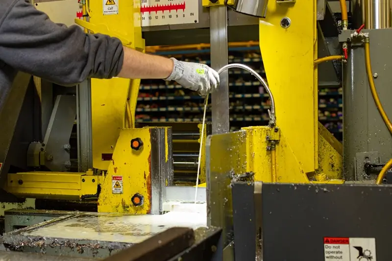 Source One Metals employee cutting metal