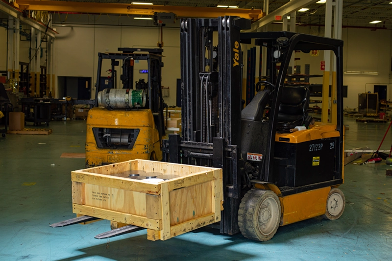 Metal forms in wood packaging on forklift for shipping