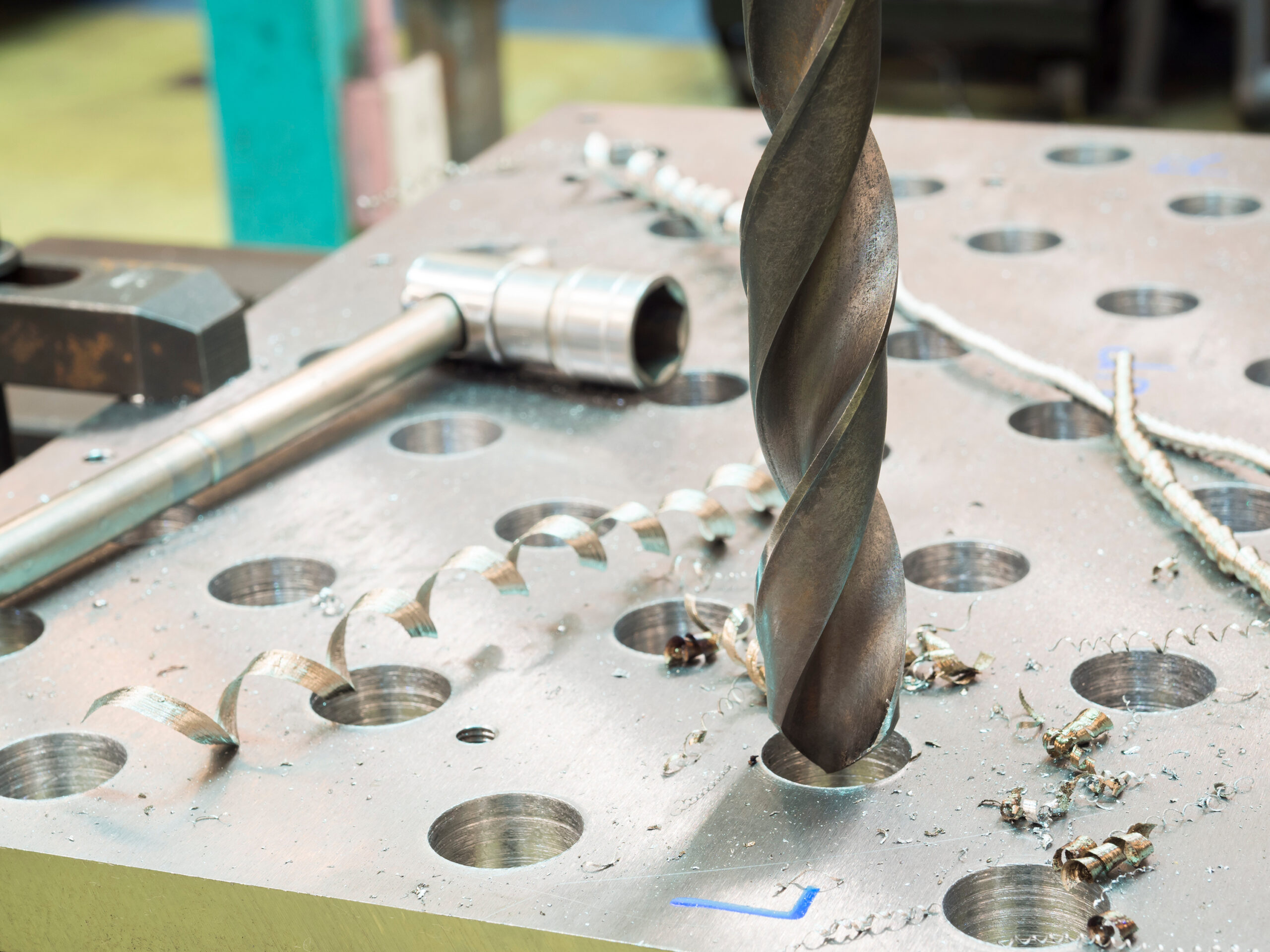 Someone drilling into a tooling plate